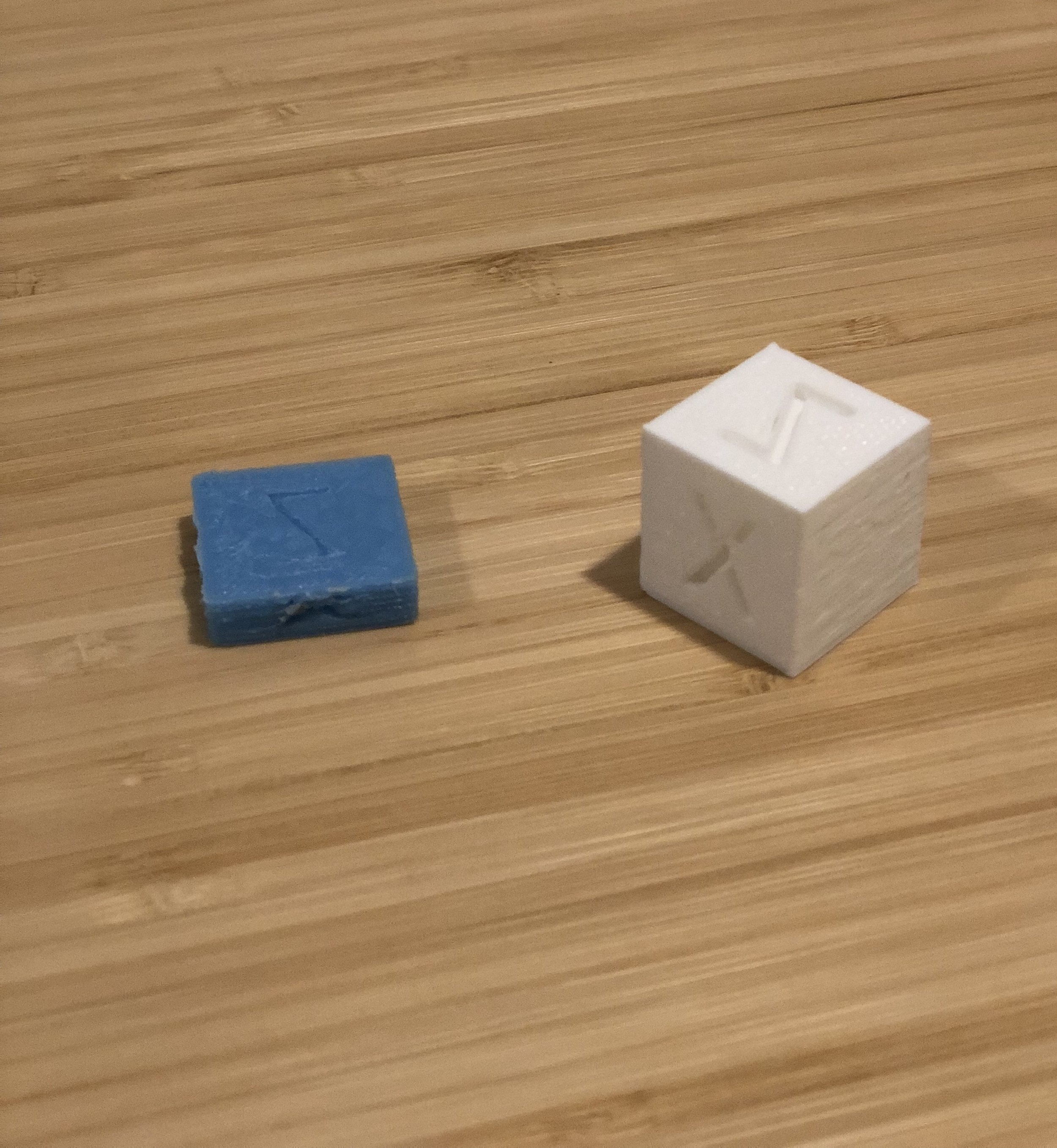 The white cube on the right is in the right range, dimensionally (20mm^3). The blue one on the left is 20mmx20mmx6mm.